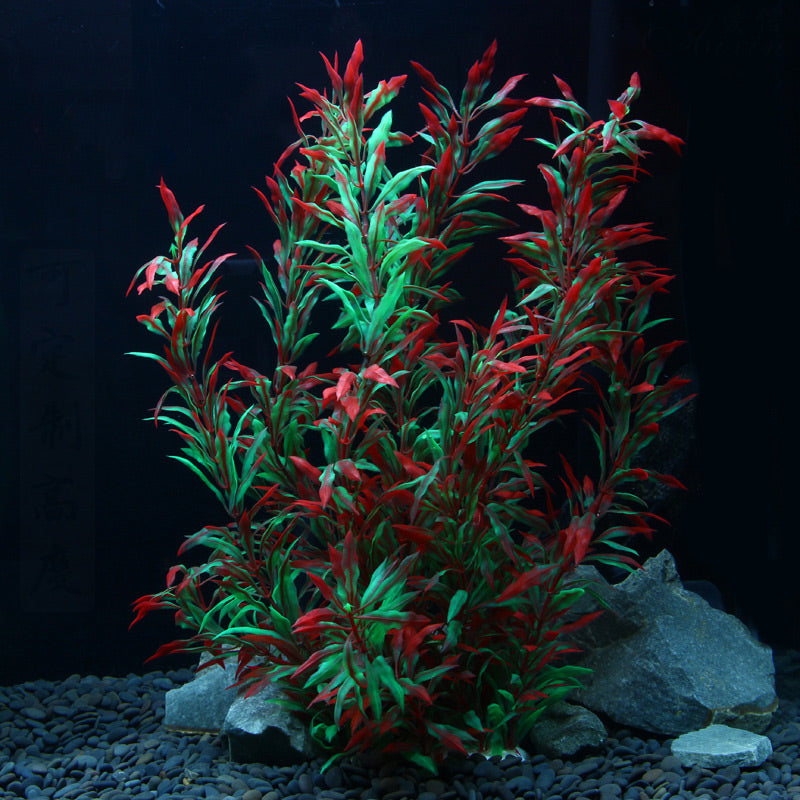 Red and green plastic plant in aquarium