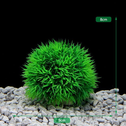plastic green moss ball in fish tank with white gravel