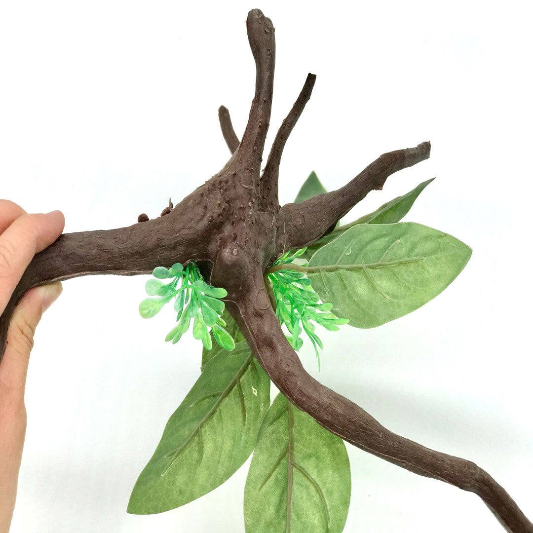 Plastic driftwood decoration with green plant